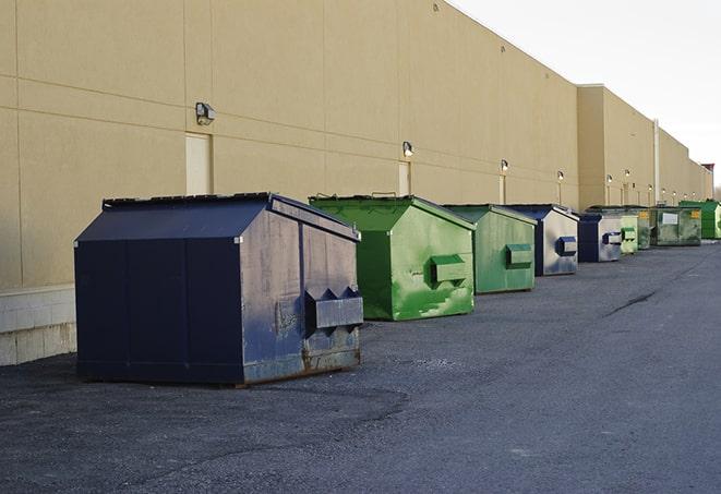 a series of colorful, utilitarian dumpsters deployed in a construction site in Bermuda Dunes, CA